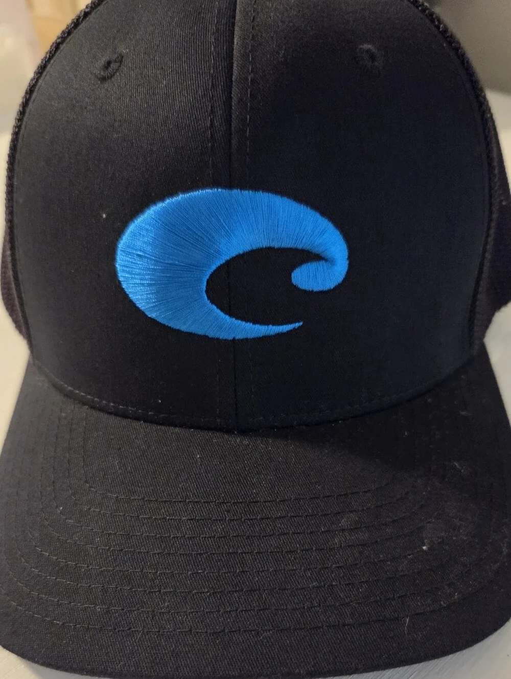 Costa Men’s Black Cap with Bright Blue Wave